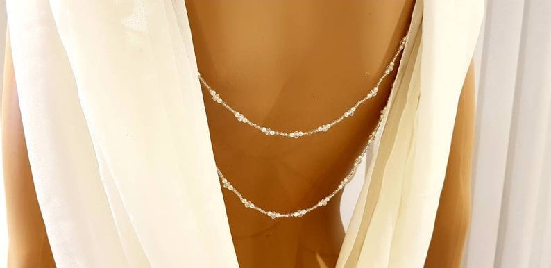 Bride wearing pearl back accessory