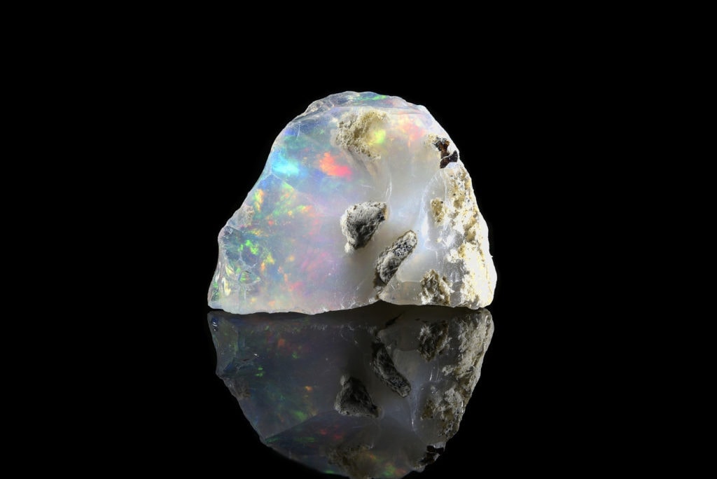 Sample of a beautiful Opal speciment isolated on black background