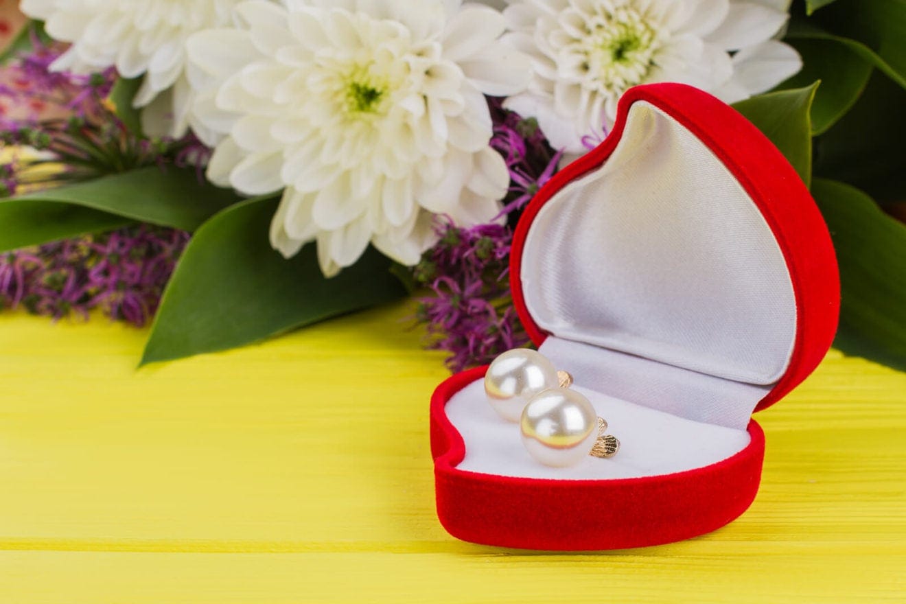 Heart-shaped Box With Earring And Flowers. Valentines Day Background With Pearl Earrings