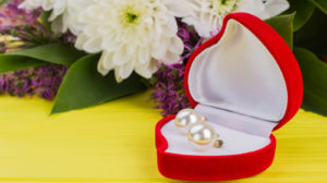 Heart-shaped Box With Earring And Flowers. Valentines Day Background With Pearl Earrings